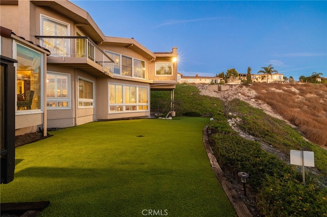 view of yard featuring a balcony