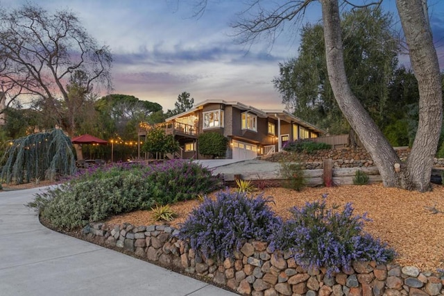 exterior space with a garage and a wooden deck