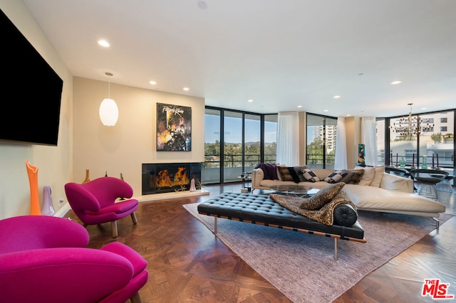 living room featuring expansive windows and dark parquet floors