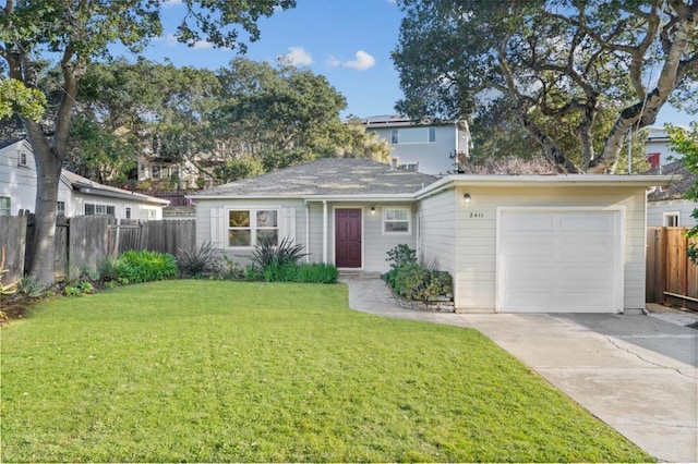 view of front of house featuring a garage and a front lawn