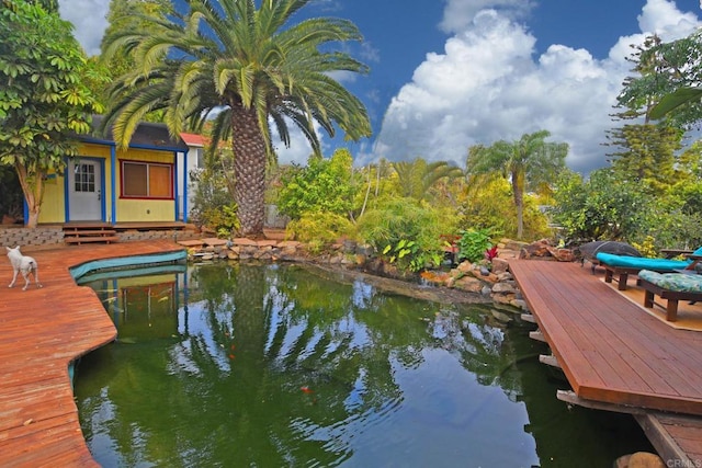 view of dock featuring a deck with water view