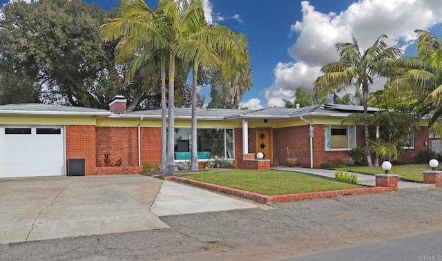 ranch-style home featuring a garage and a front lawn