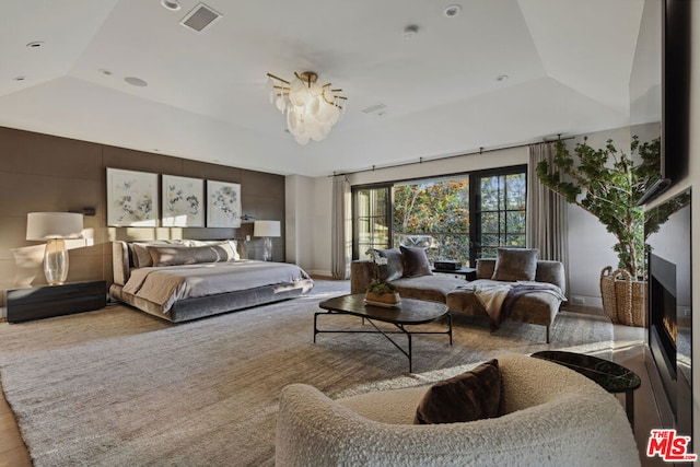 bedroom with lofted ceiling and a tray ceiling