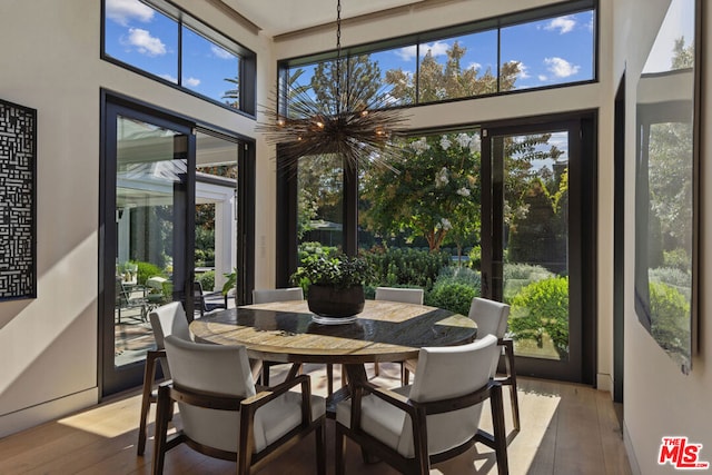 sunroom with an inviting chandelier