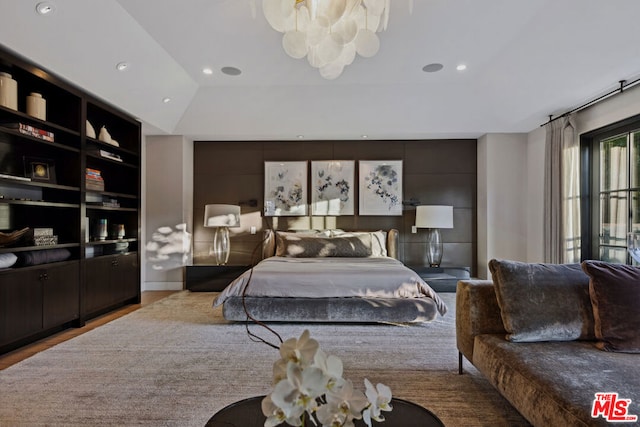 bedroom featuring lofted ceiling and light wood-type flooring