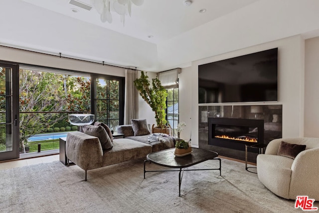 living room featuring a tile fireplace