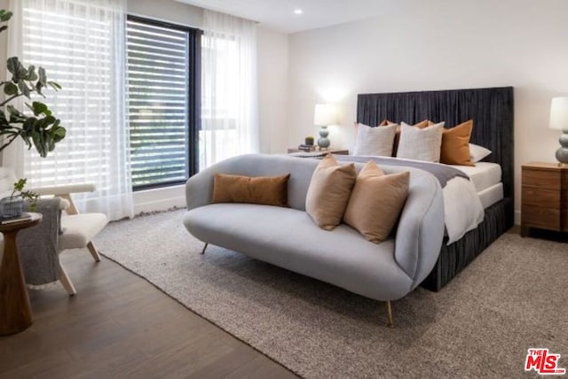 bedroom featuring hardwood / wood-style flooring and multiple windows