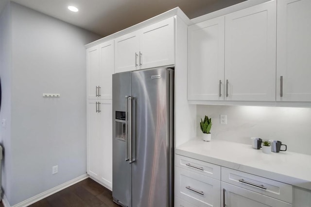 kitchen with white cabinetry, high quality fridge, and dark wood-type flooring