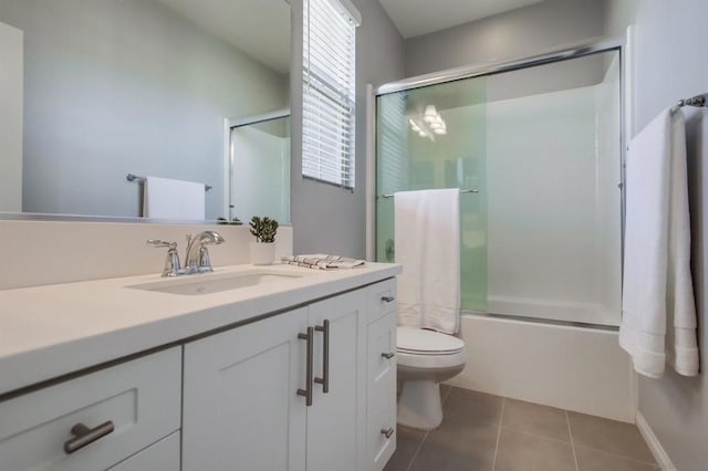 full bathroom with vanity, combined bath / shower with glass door, tile patterned floors, and toilet