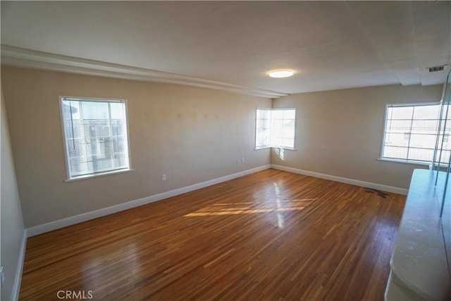 empty room featuring dark hardwood / wood-style flooring