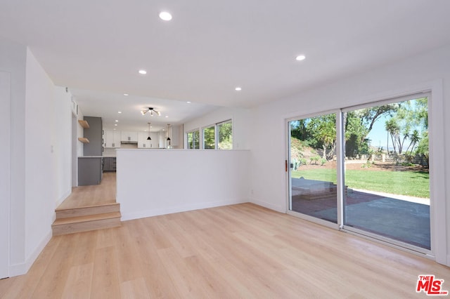 unfurnished living room with light wood-type flooring