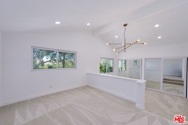 spare room with an inviting chandelier, light colored carpet, and lofted ceiling with beams