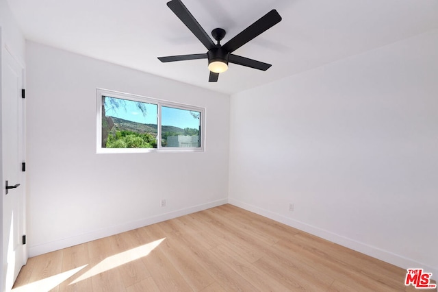 spare room featuring ceiling fan and light wood-type flooring