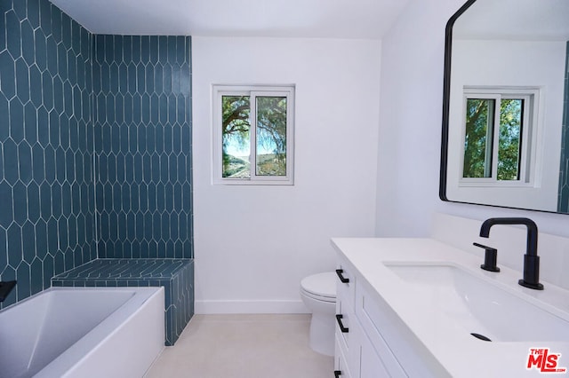 bathroom featuring vanity, plenty of natural light, and toilet