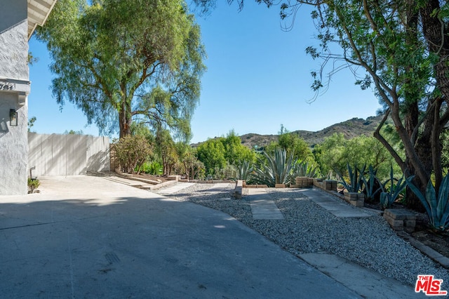 view of yard with a mountain view and a patio