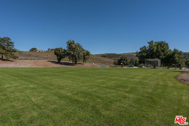 view of yard with a mountain view and a rural view