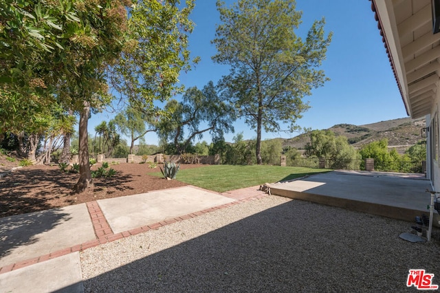 view of yard with a mountain view and a patio area