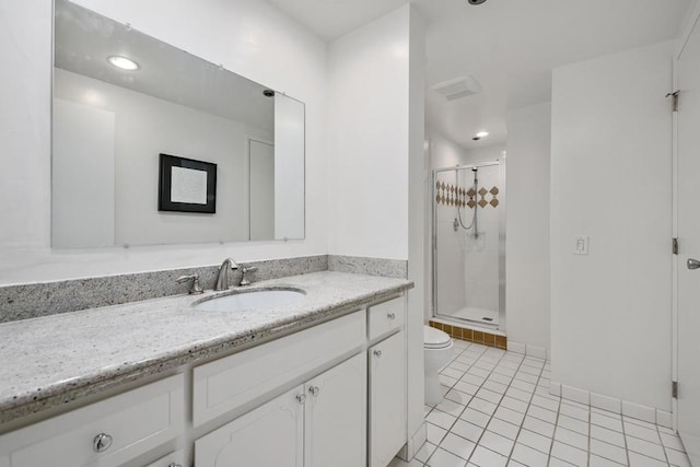 bathroom with vanity, a shower with shower door, tile patterned floors, and toilet