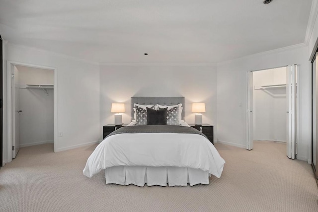 bedroom with crown molding, a walk in closet, and light carpet