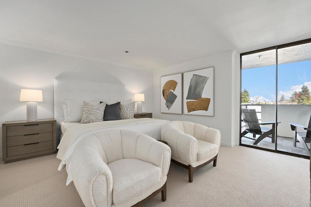 bedroom with access to exterior, light colored carpet, and expansive windows