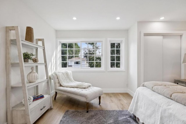 bedroom with light hardwood / wood-style flooring and a closet