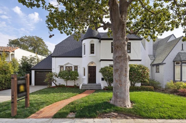 view of front of property featuring a garage and a front lawn