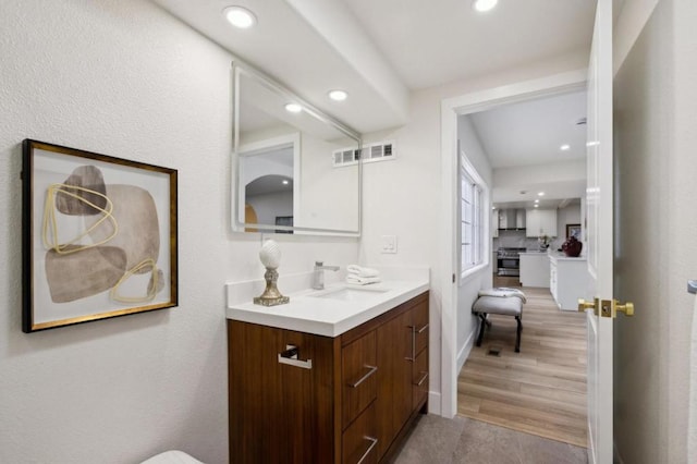 bathroom with hardwood / wood-style flooring and vanity