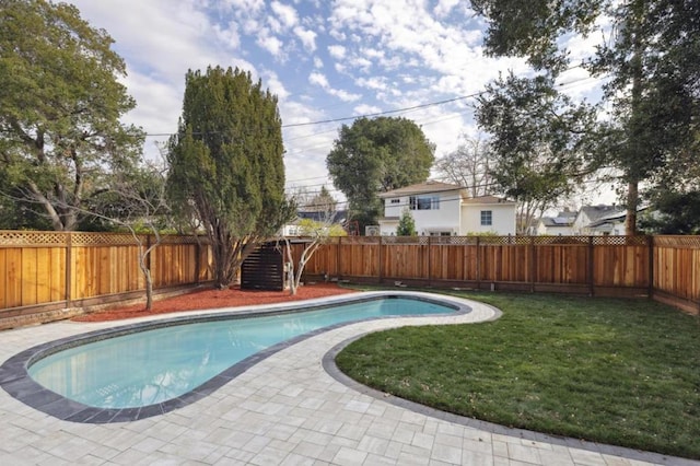 view of pool with a patio and a lawn