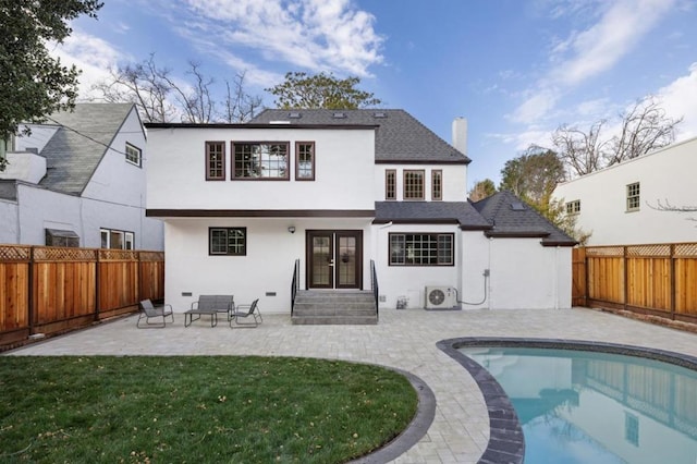 rear view of property with a fenced in pool, a patio, ac unit, and a lawn