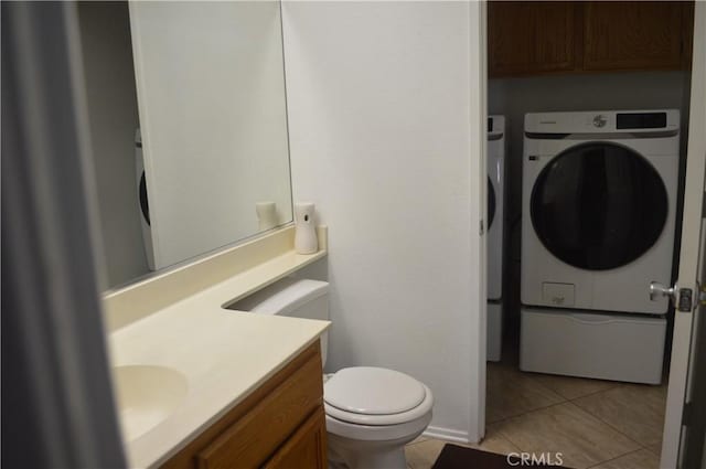 bathroom with tile patterned flooring, washer / clothes dryer, vanity, and toilet