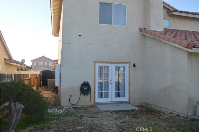 rear view of property with central AC and french doors