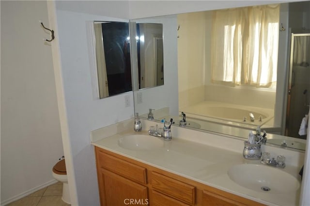 bathroom featuring vanity, a bath, tile patterned floors, and toilet