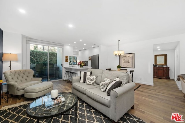 living room featuring hardwood / wood-style floors and a chandelier