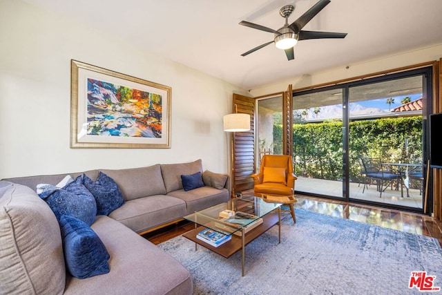 living room featuring hardwood / wood-style floors and ceiling fan