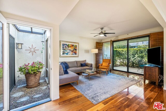 living room featuring hardwood / wood-style floors and ceiling fan