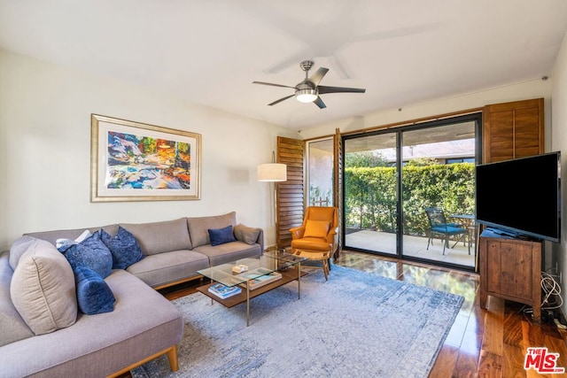 living room featuring ceiling fan and wood-type flooring