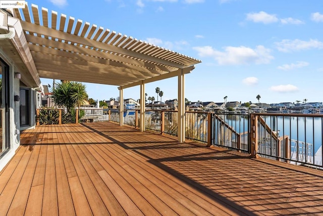 deck with a pergola and a water view