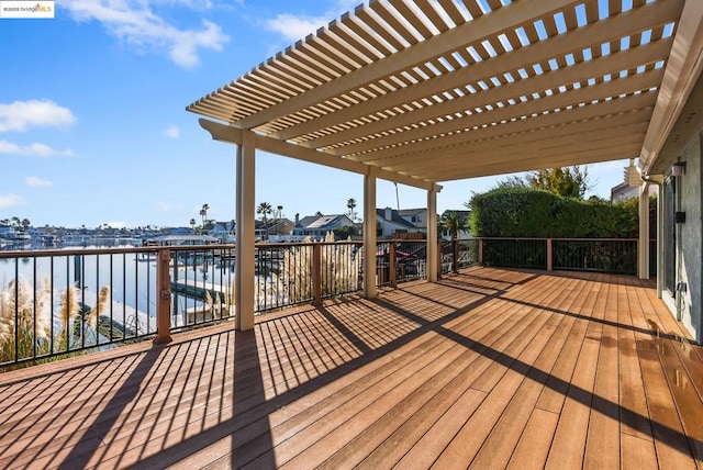 wooden deck featuring a pergola and a water view