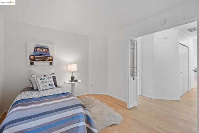 bedroom with hardwood / wood-style floors