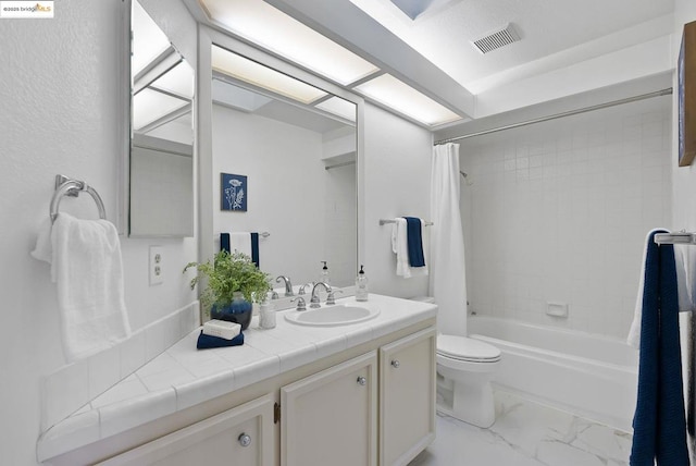 full bathroom with vanity, shower / tub combo, and toilet