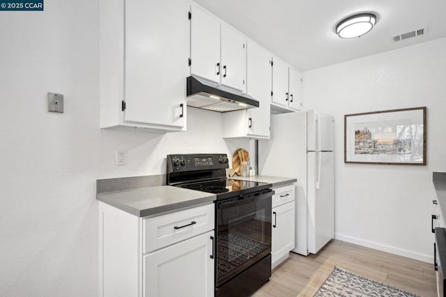 kitchen featuring white refrigerator, white cabinetry, electric range, and light hardwood / wood-style floors