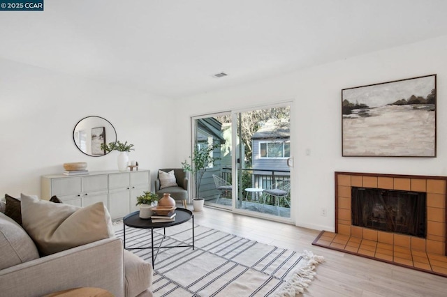 living room featuring a fireplace and light hardwood / wood-style floors