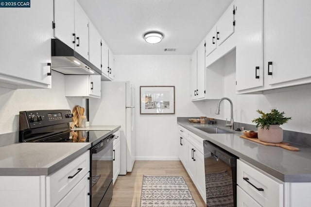 kitchen featuring white cabinetry, sink, black appliances, and light wood-type flooring