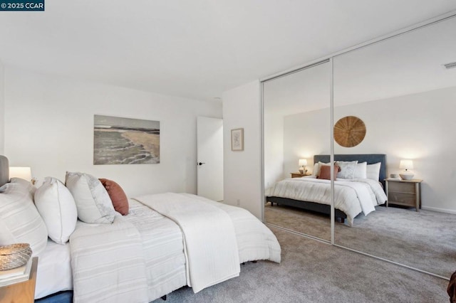 bedroom with a closet and carpet flooring