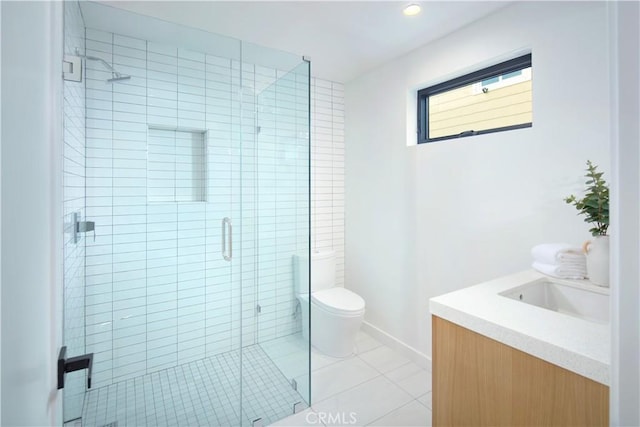 bathroom featuring toilet, tile patterned flooring, vanity, and walk in shower