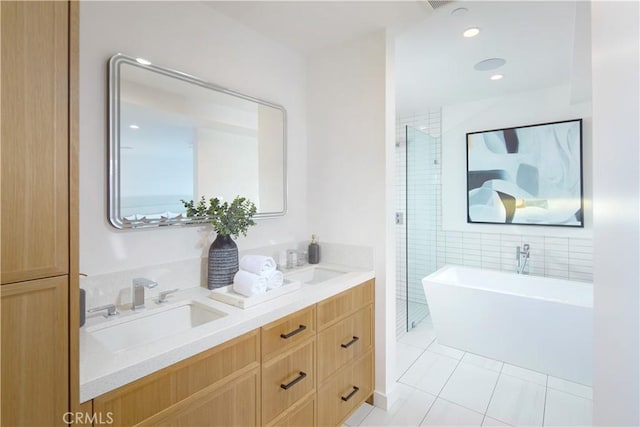 bathroom featuring vanity, a tub, and tile patterned floors