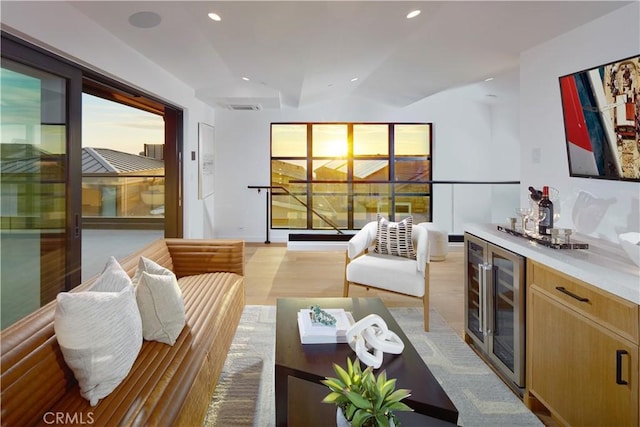 living room featuring wine cooler and bar area