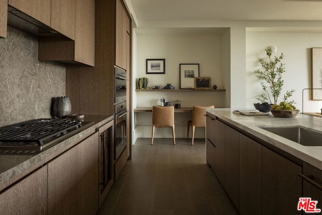 kitchen with tasteful backsplash, stainless steel appliances, dark hardwood / wood-style floors, and sink