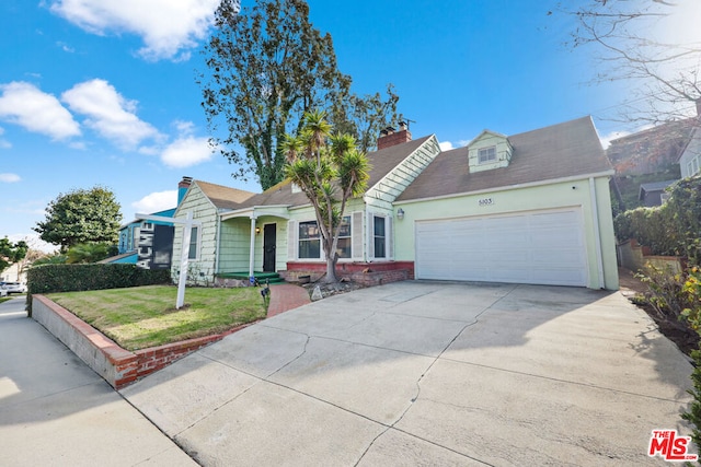 view of front of home with a garage and a front lawn