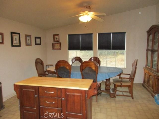 dining room featuring lofted ceiling and a ceiling fan